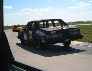 Illustration for article titled $20 Bumper-Mounted Still Camera Works Great On The Race Track... Until It Gets Smashed
